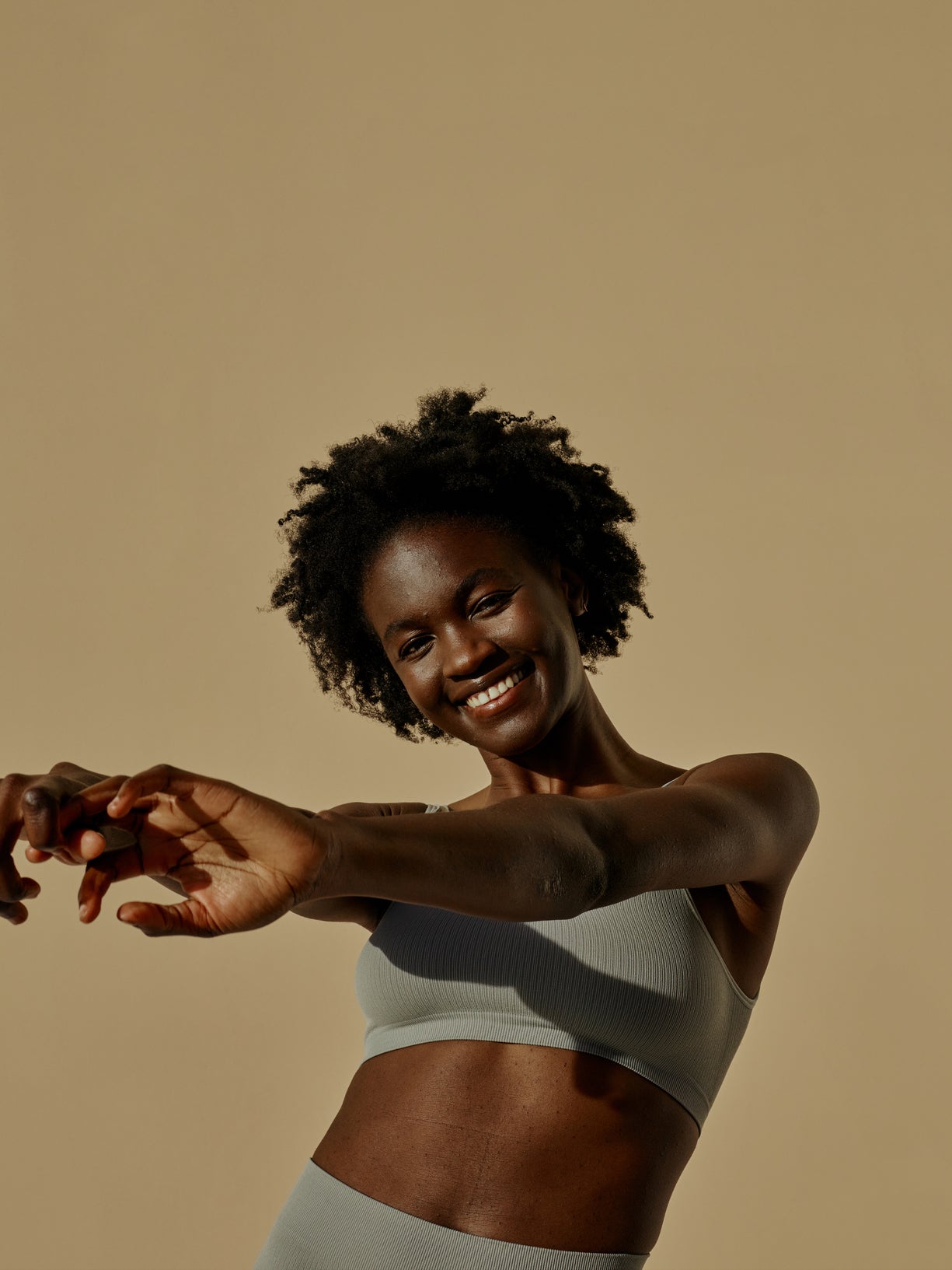 Woman in athleisure showing off toned abs