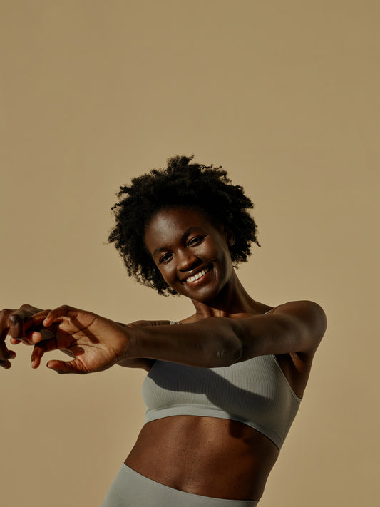 Woman in athleisure showing off toned abs